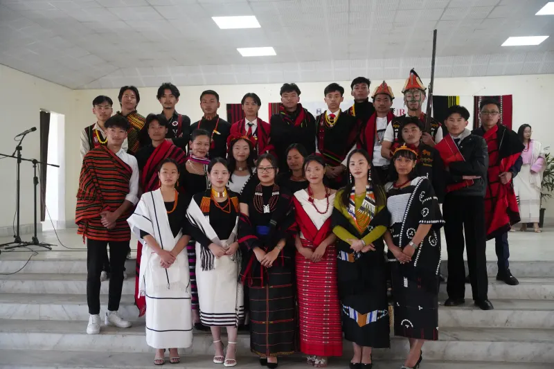 Students in traditional Naga attire on stage at Cultural Day